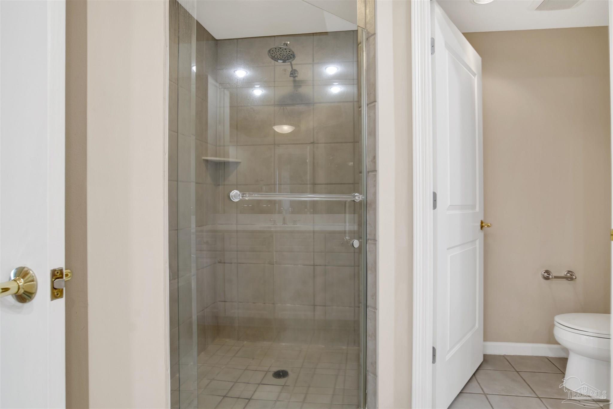 608 Lost Key Drive, Unit 701C Pensacola, FL 32507 - Photo 25 of 32 a bathroom with a shower and a toilet