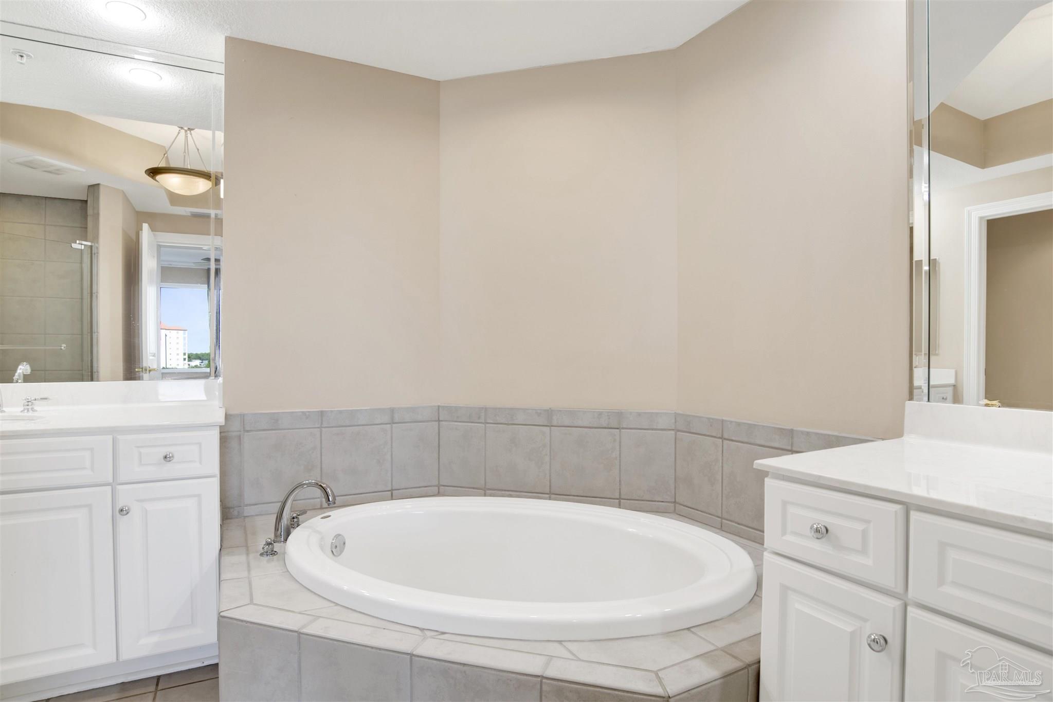 608 Lost Key Drive, Unit 701C Pensacola, FL 32507 - Photo 26 of 32 a bathroom with a bathtub and sink