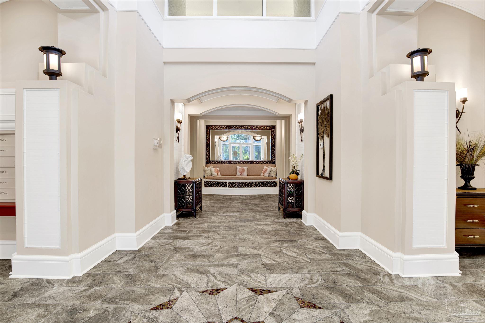 608 Lost Key Drive, Unit 701C Pensacola, FL 32507 - Photo 28 of 32 a view of a hallway with wooden floor and a fireplace