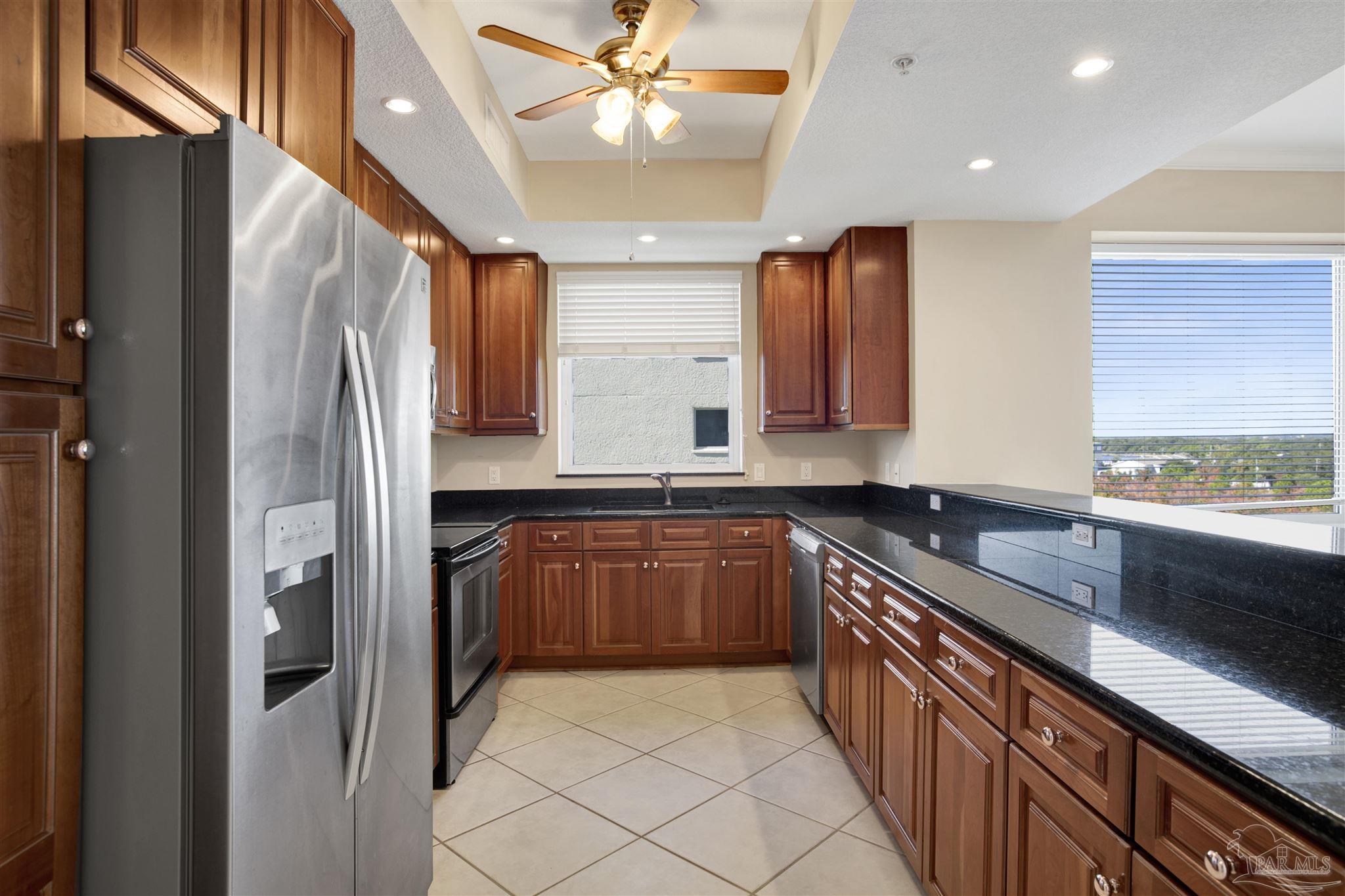 608 Lost Key Drive, Unit 701C Pensacola, FL 32507 - Photo 10 of 32 a kitchen with stainless steel appliances granite countertop a refrigerator and a sink