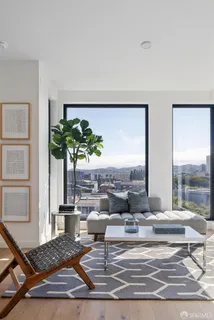 a living room with patio furniture and a potted plant