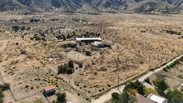 a view of a dry yard with wooden fence