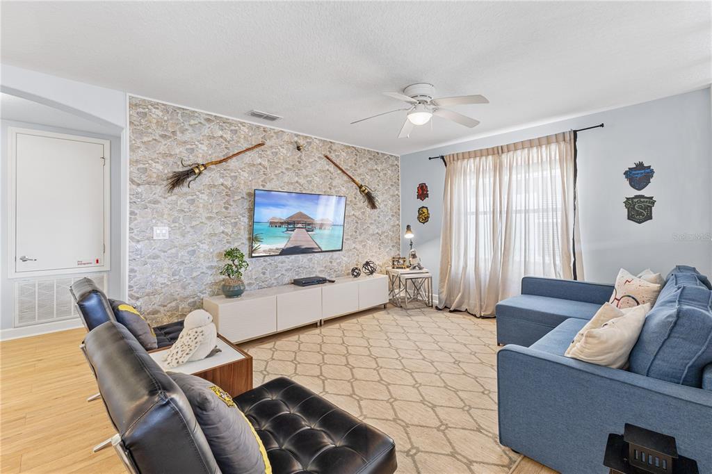 9006 Majesty Palm Road Kissimmee, FL 34747 - Photo 34 of 56 a living room with furniture and a large window
