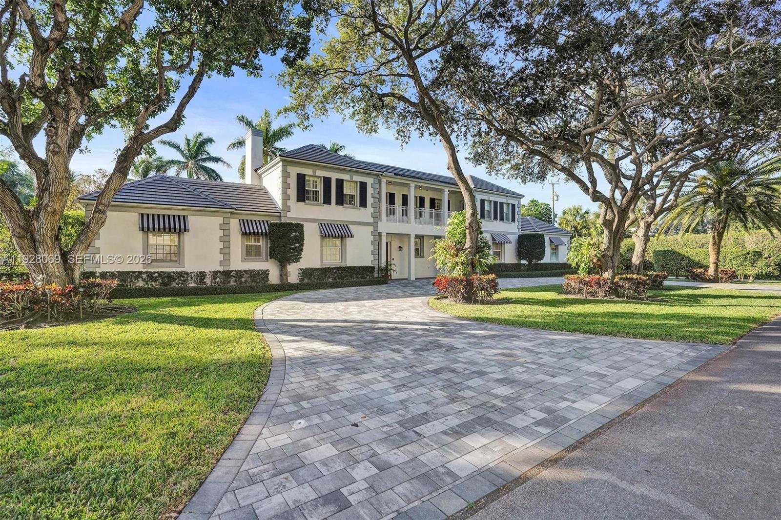 1281 Banyan Road Boca Raton, FL 33432 - Photo 8 of 69 a front view of a house with a yard and trees