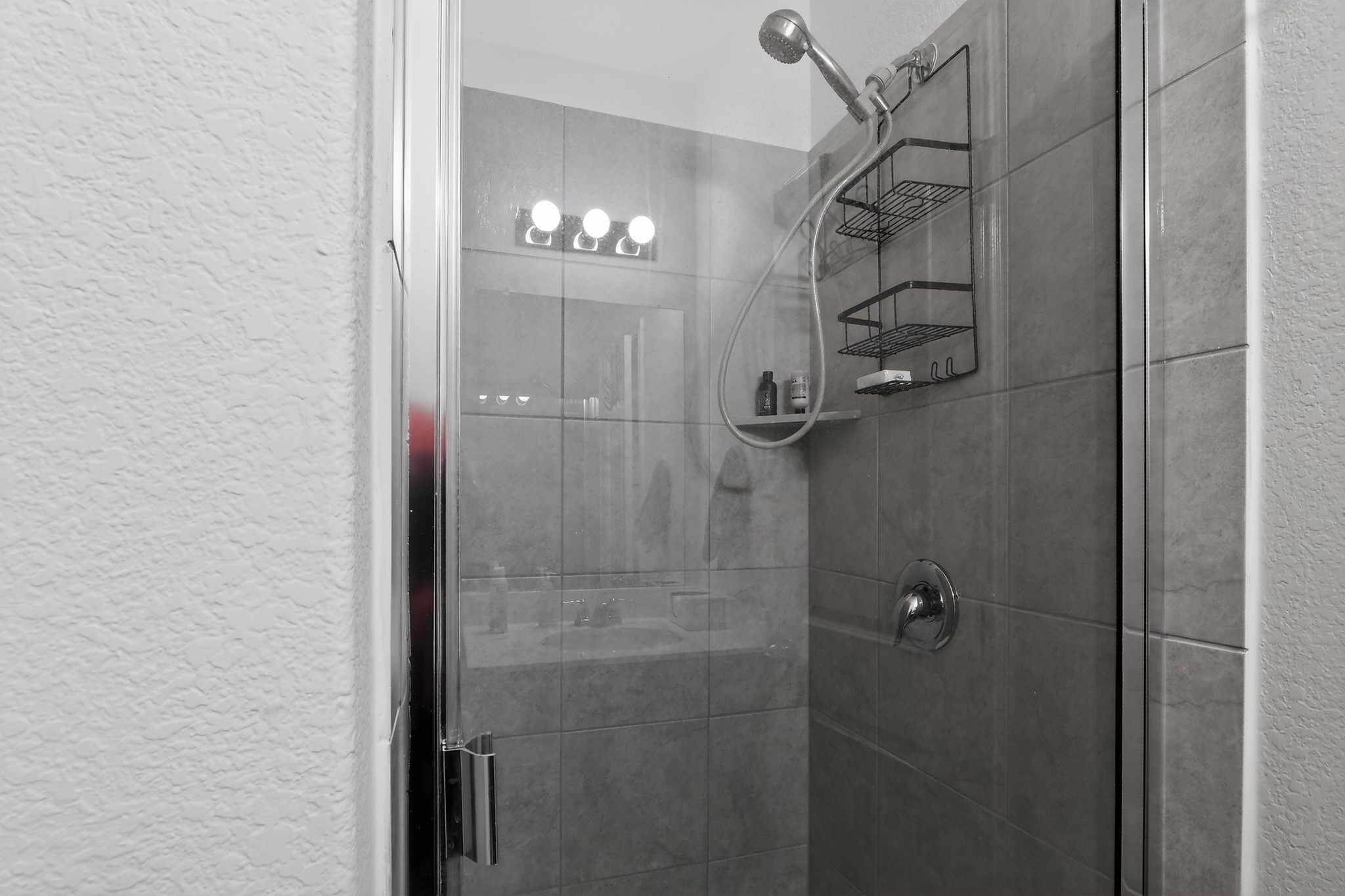 521 Staton Street Georgetown, TX 78626 - Photo 33 of 39 a bathroom with a glass shower door and a chandelier fan