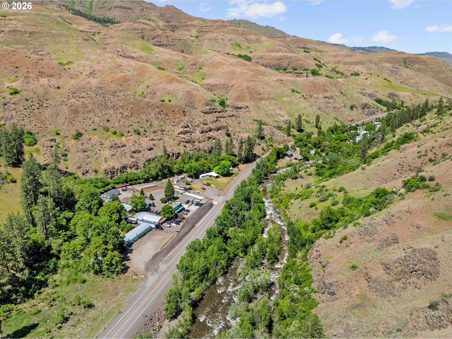53945 Highway 86 Halfway, OR 97834 - Photo 11 of 48 an aerial view of mountain with residential house and mountains in the background