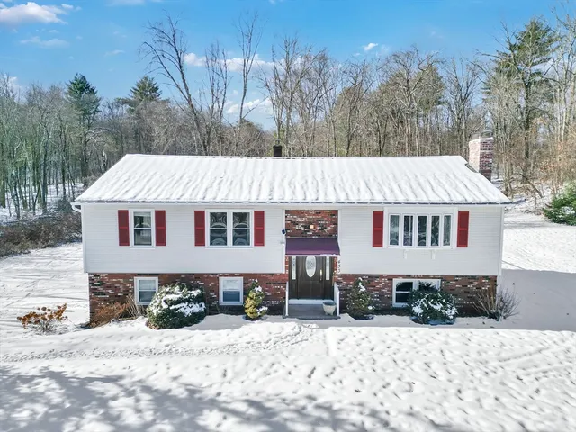 a aerial view of a house with a yard covered in snow