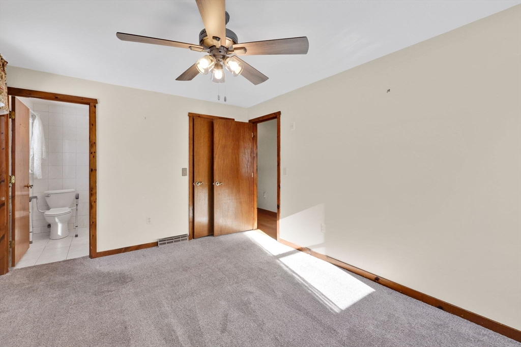 433 Ventura Street Ludlow, MA 01056 - Photo 18 of 39 an empty room with a chandelier fan and windows