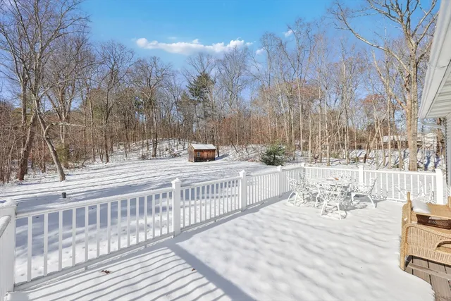 a white house with a tree in front of it