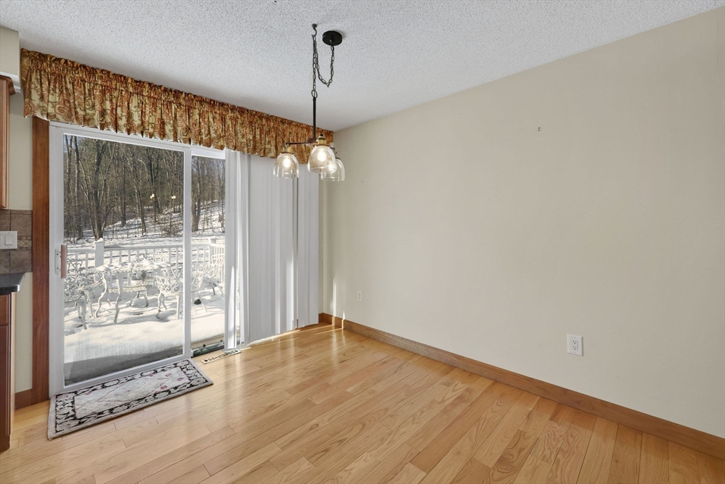 433 Ventura Street Ludlow, MA 01056 - Photo 7 of 39 a view of a livingroom with wooden floor a chandelier and windows