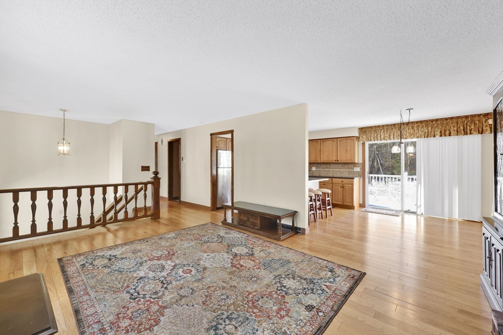 433 Ventura Street Ludlow, MA 01056 - Photo 9 of 39 a view of a big room with wooden floor and windows