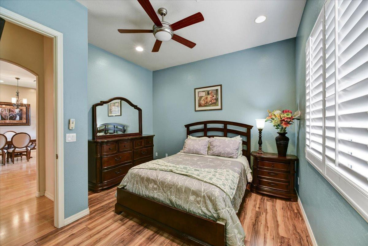412 East Yearling Road Phoenix, AZ 85085 - Photo 19 of 51 a bedroom with a bed and a chandelier