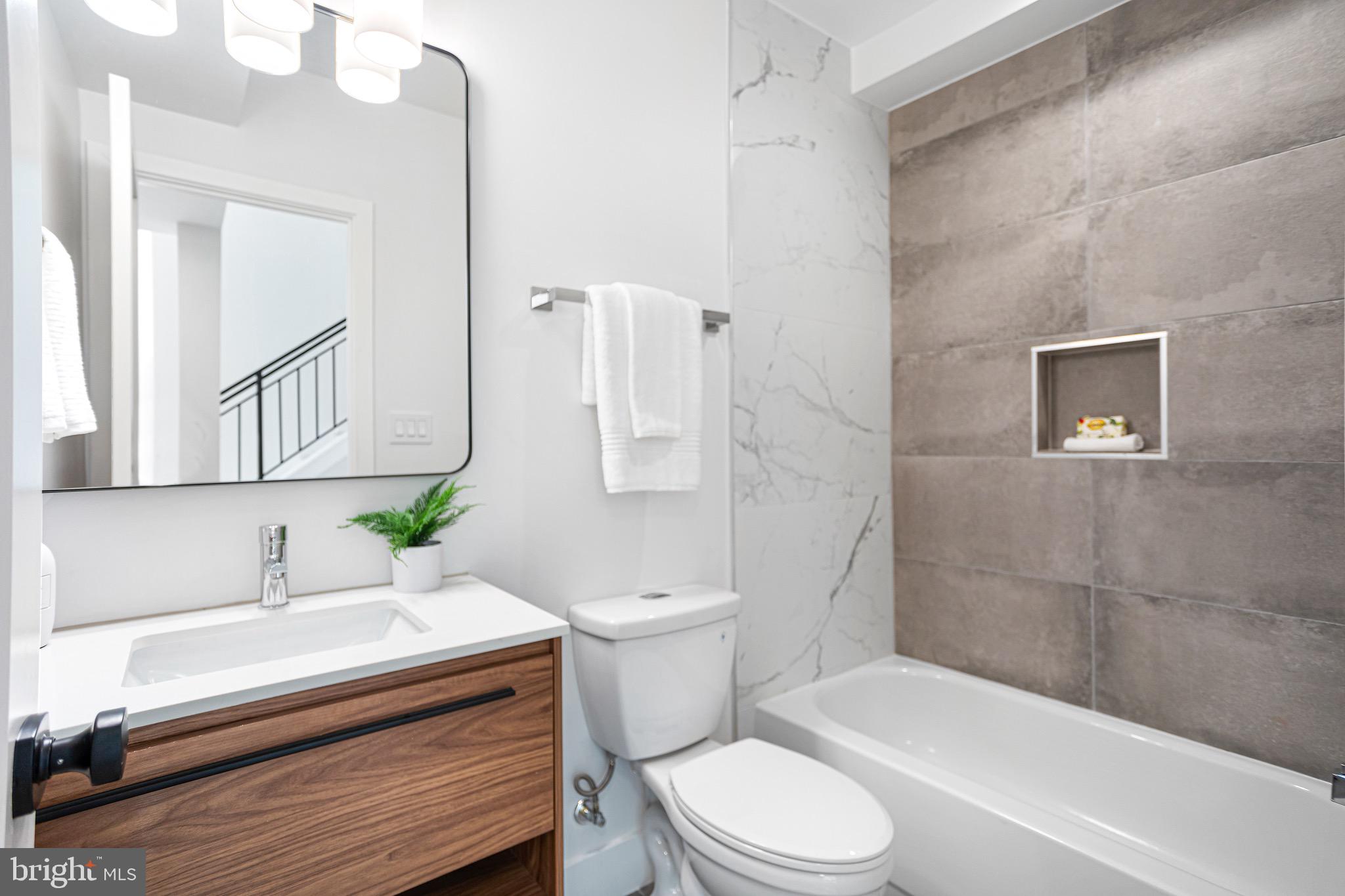 845 19th Street Northeast, Unit 10 Washington, DC 20002 - Photo 12 of 22 a bathroom with a sink a toilet and bathtub