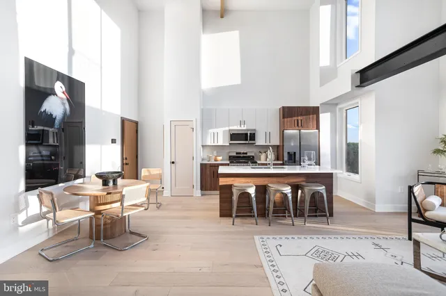 a large kitchen with a table and chairs
