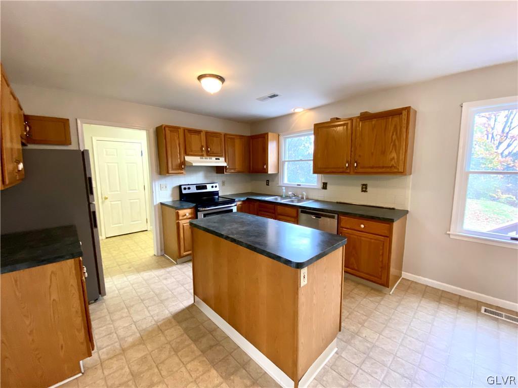 4755 McDermott Road Bangor, PA 18013 - Photo 9 of 37 a kitchen with granite countertop a stove top oven a sink a counter top space and cabinets