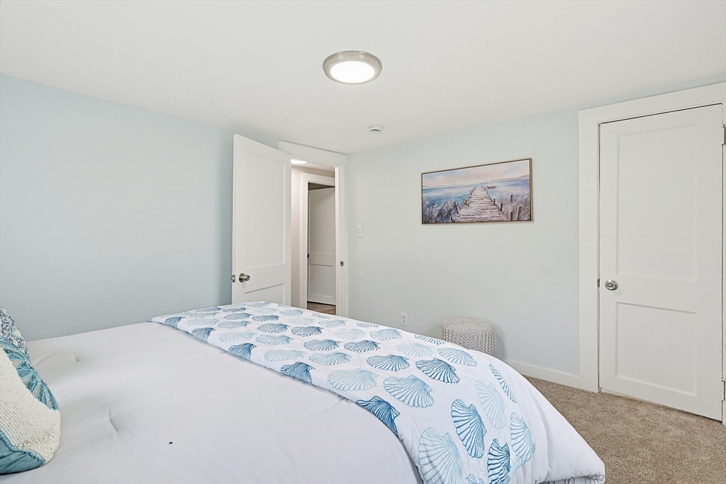 24 Otis Road Barnstable, MA 02601 - Photo 19 of 33 a bedroom with a bed and a painting on the wall