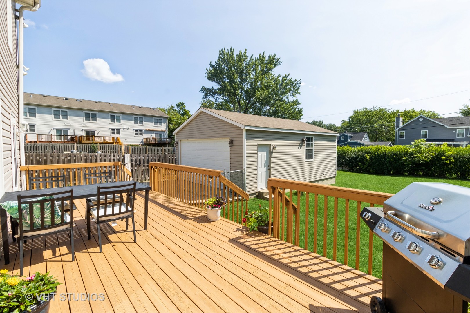 49 South Quentin Road Palatine, IL 60067 - Photo 24 of 25 a view of a roof deck with table and chairs with wooden floor