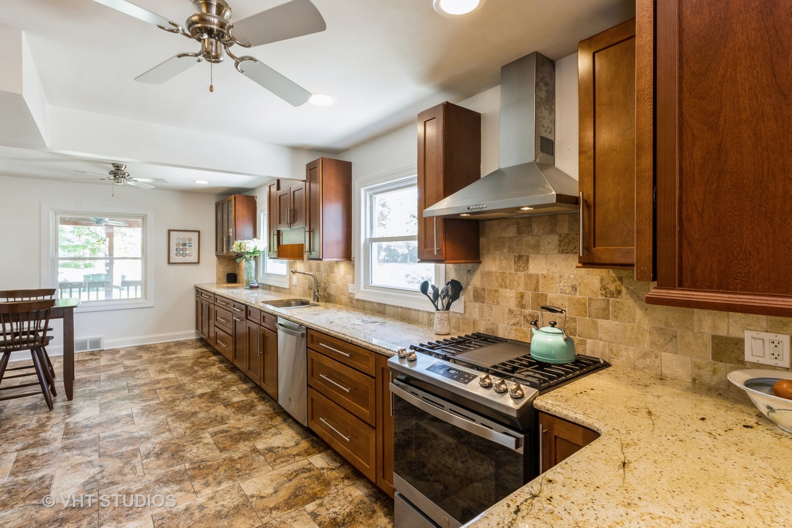 49 South Quentin Road Palatine, IL 60067 - Photo 9 of 25 a kitchen with stainless steel appliances granite countertop a stove a sink and a refrigerator