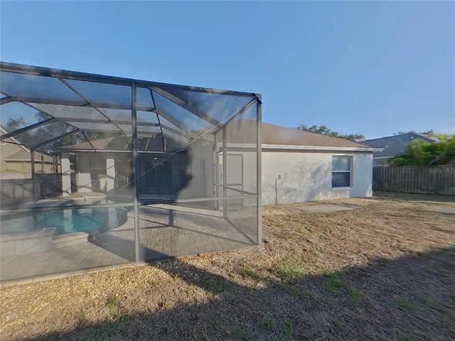 a view of a house with a backyard