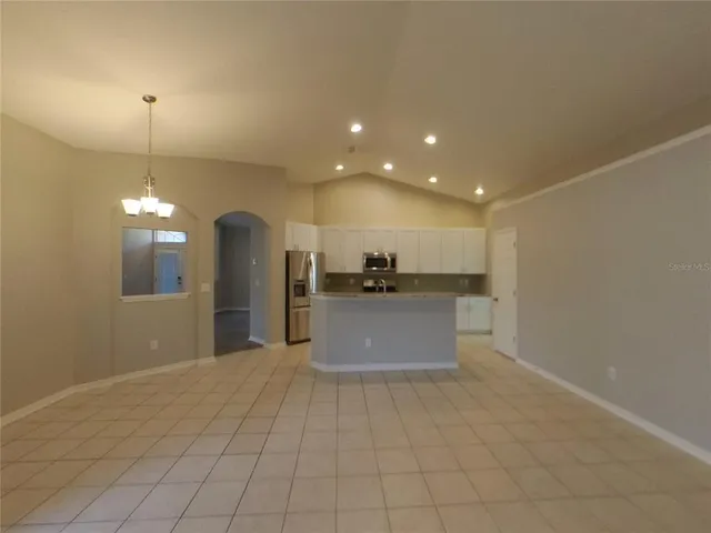 a view of kitchen with refrigerator and window