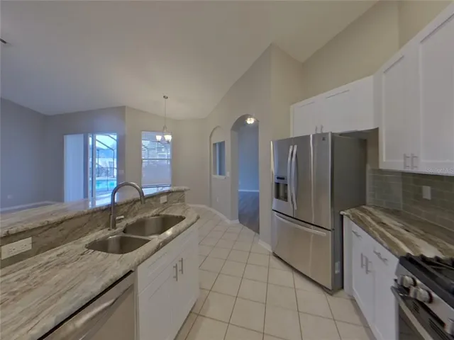 a kitchen with a sink cabinets and stainless steel appliances