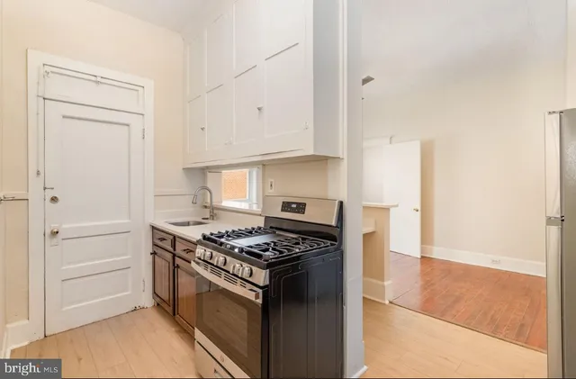 a kitchen with cabinets and appliances