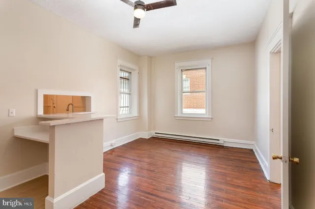 wooden floor in an empty room with a window