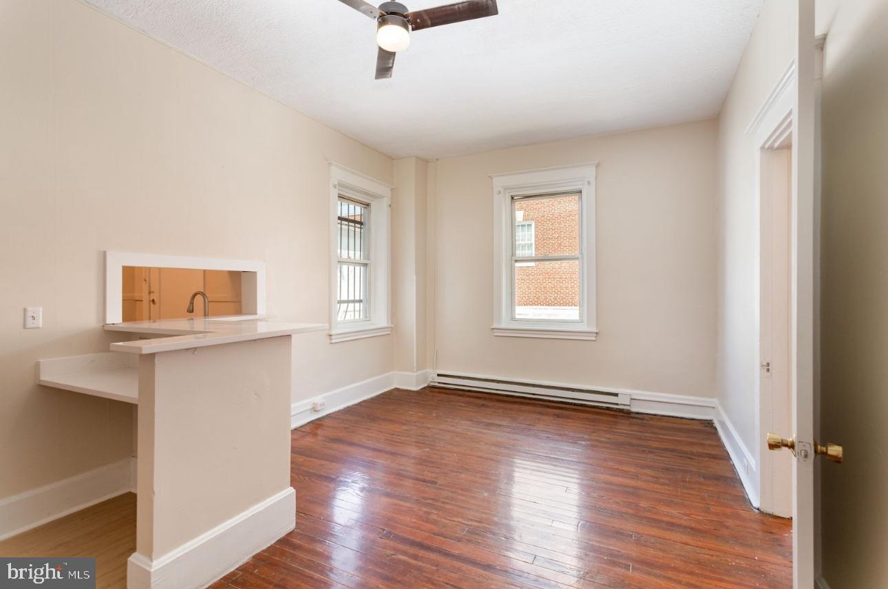 32 West High Street, Unit 301 Carlisle, PA 17013 - Photo 4 of 11 wooden floor in an empty room with a window