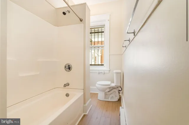 a bathroom with a sink a toilet and bathtub