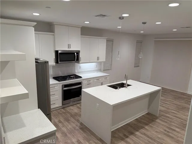 a kitchen that has a sink and a stove in it