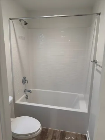 a white toilet sitting next to a bathroom sink