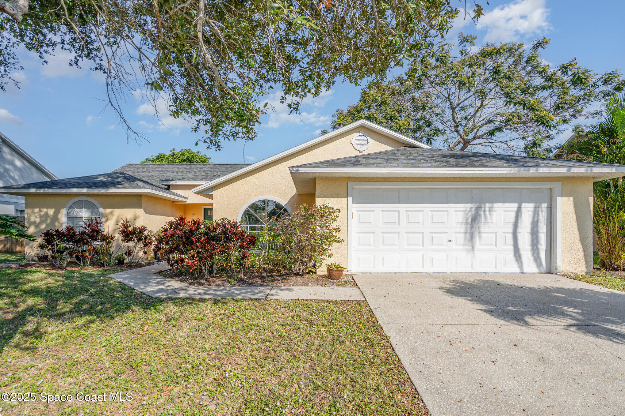 636 Fishtail Palm Boulevard Melbourne, FL 32901 - Photo 1 of 25 a front view of a house with a yard