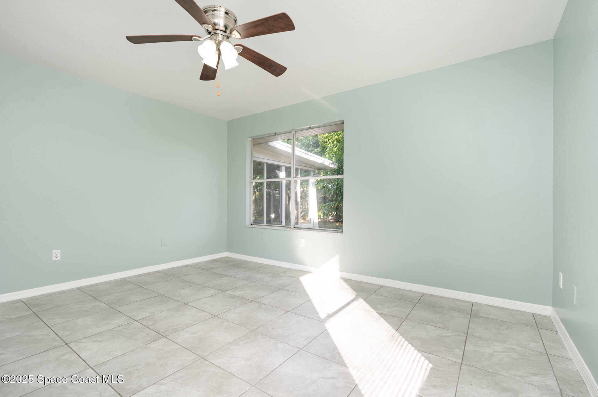 636 Fishtail Palm Boulevard Melbourne, FL 32901 - Photo 13 of 25 a view of an empty room with window and chandelier fan