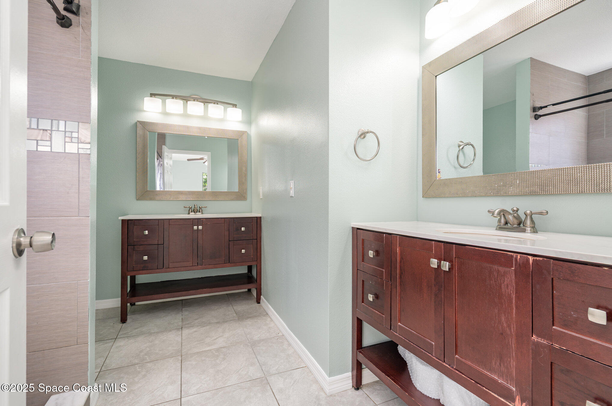 636 Fishtail Palm Boulevard Melbourne, FL 32901 - Photo 15 of 25 a bathroom with a sink and a mirror