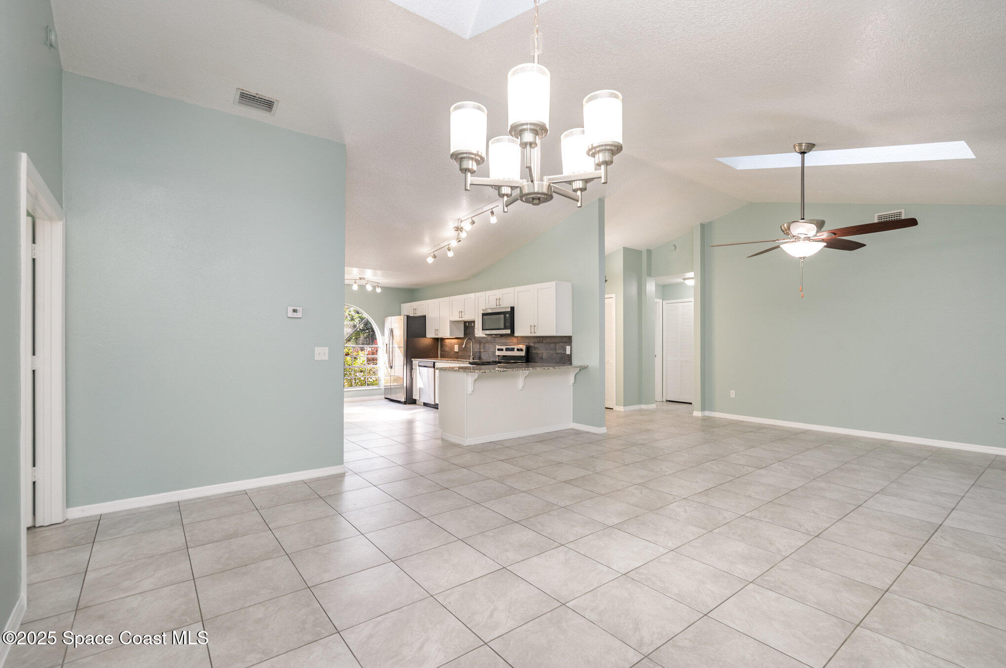 636 Fishtail Palm Boulevard Melbourne, FL 32901 - Photo 5 of 25 a view of an empty room and kitchen view