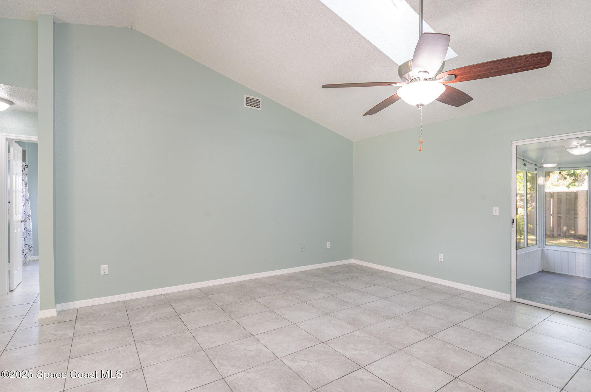 636 Fishtail Palm Boulevard Melbourne, FL 32901 - Photo 7 of 25 an empty room with fan and fan