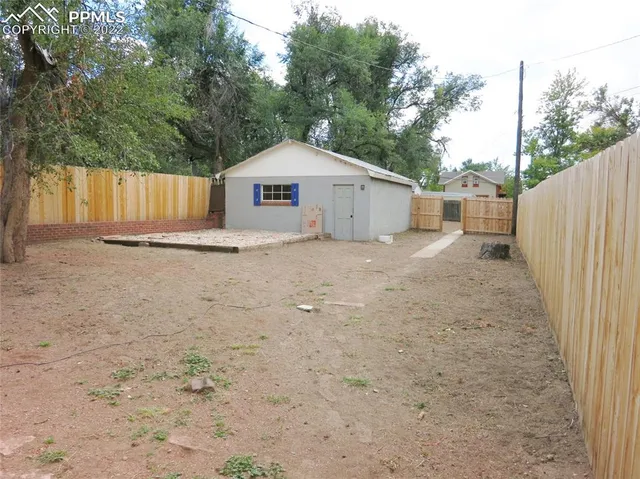 a white house that has a tree in front of it