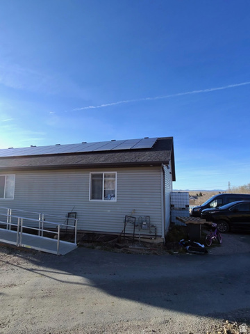 4355 Sagebrush Drive Enoch, UT 84721 - Photo 3 of 13 View of side of home featuring solar panels