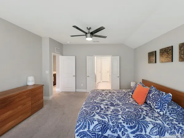 a spacious bathroom with a granite countertop sink and a mirror