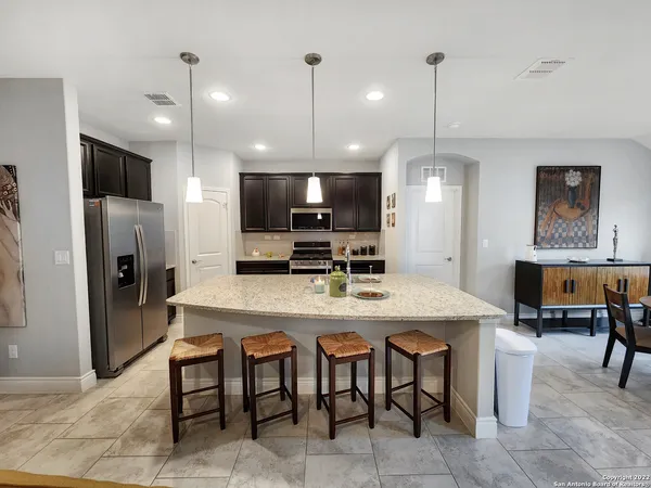 a large kitchen with a table and chairs