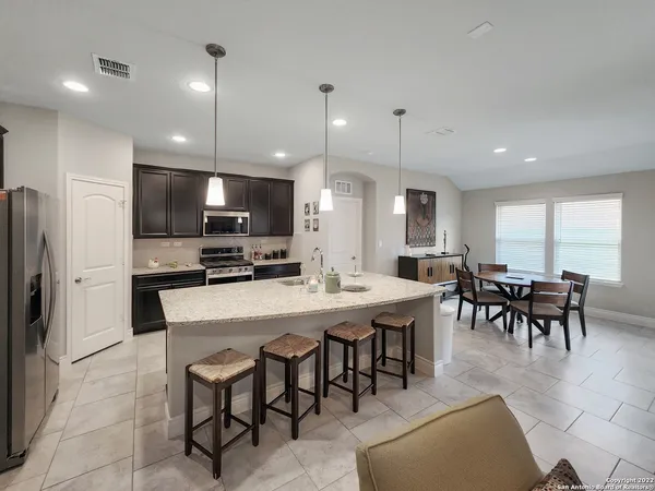 a large kitchen with a table and chairs