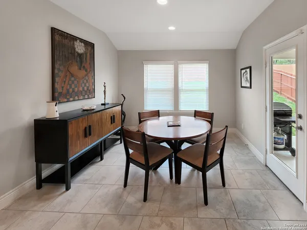 a dining room with a wooden table and chairs