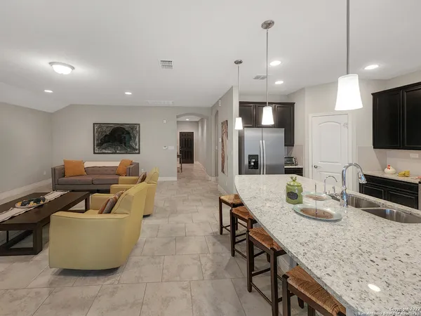 a bathroom with a granite countertop sink toilet and a mirror