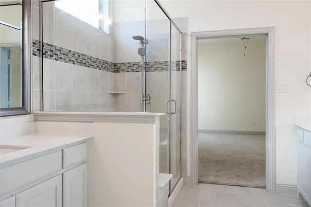 a bathroom with a shower and a sink