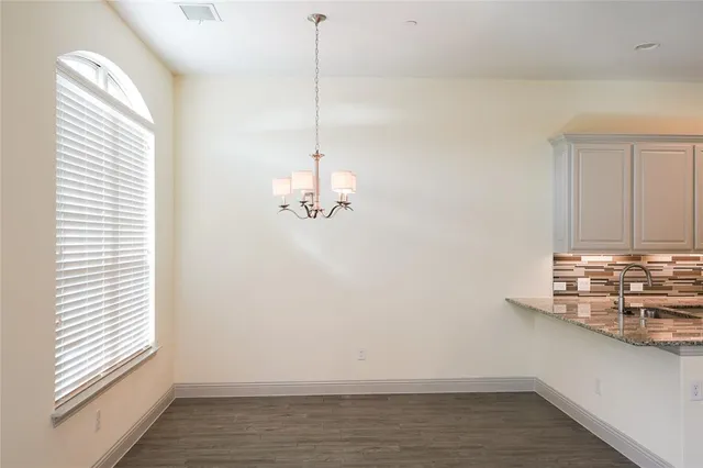 a view of a room with wooden floor and window