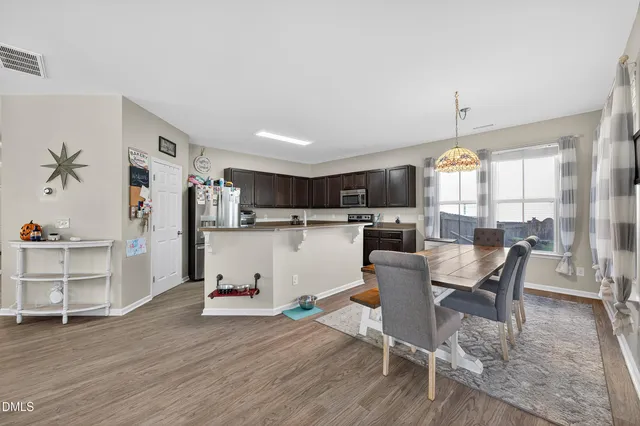 a living room with furniture and kitchen view