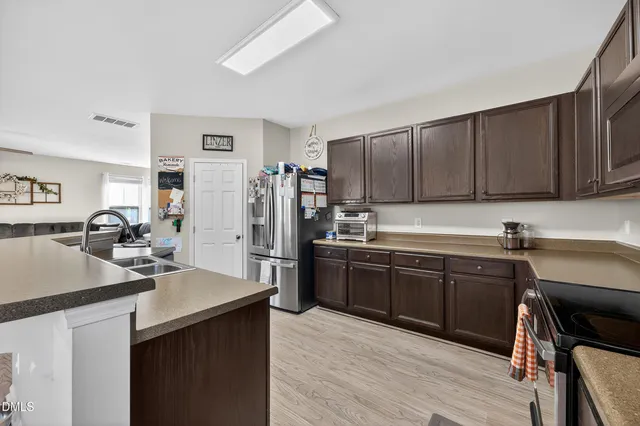 a dining room with furniture and wooden floor