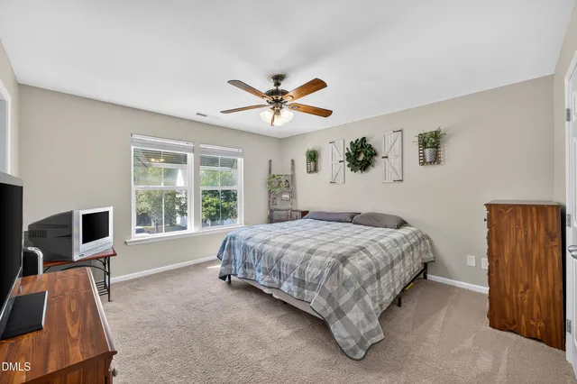 a bedroom with furniture and a large window