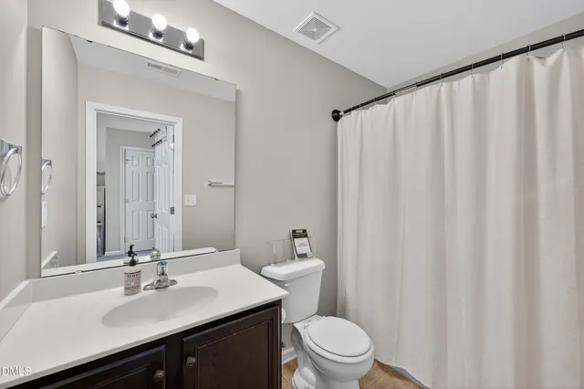 a living room with furniture a chandelier and a window