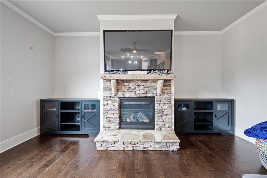 6780 Rambling Vale Dawsonville, GA 30534 - Photo 20 of 53 a living room with a fireplace and wooden floor